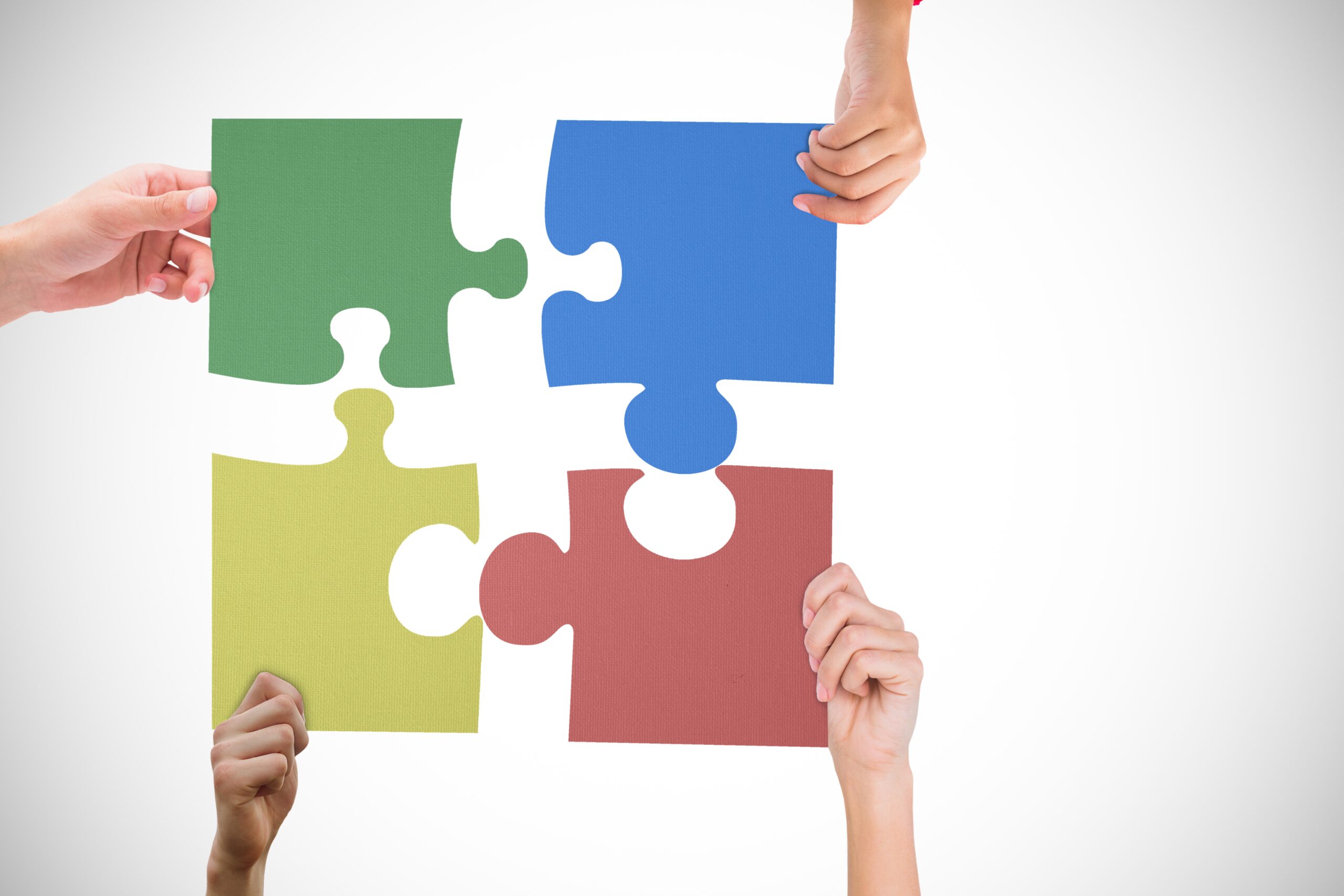 hands holding jigsaw puzzle on white background